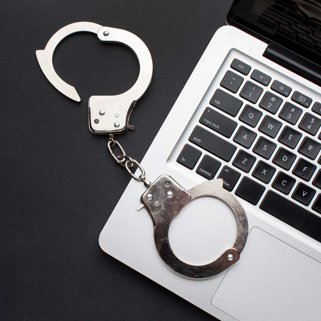 flat-lay-handcuffs-with-laptop-copy-space